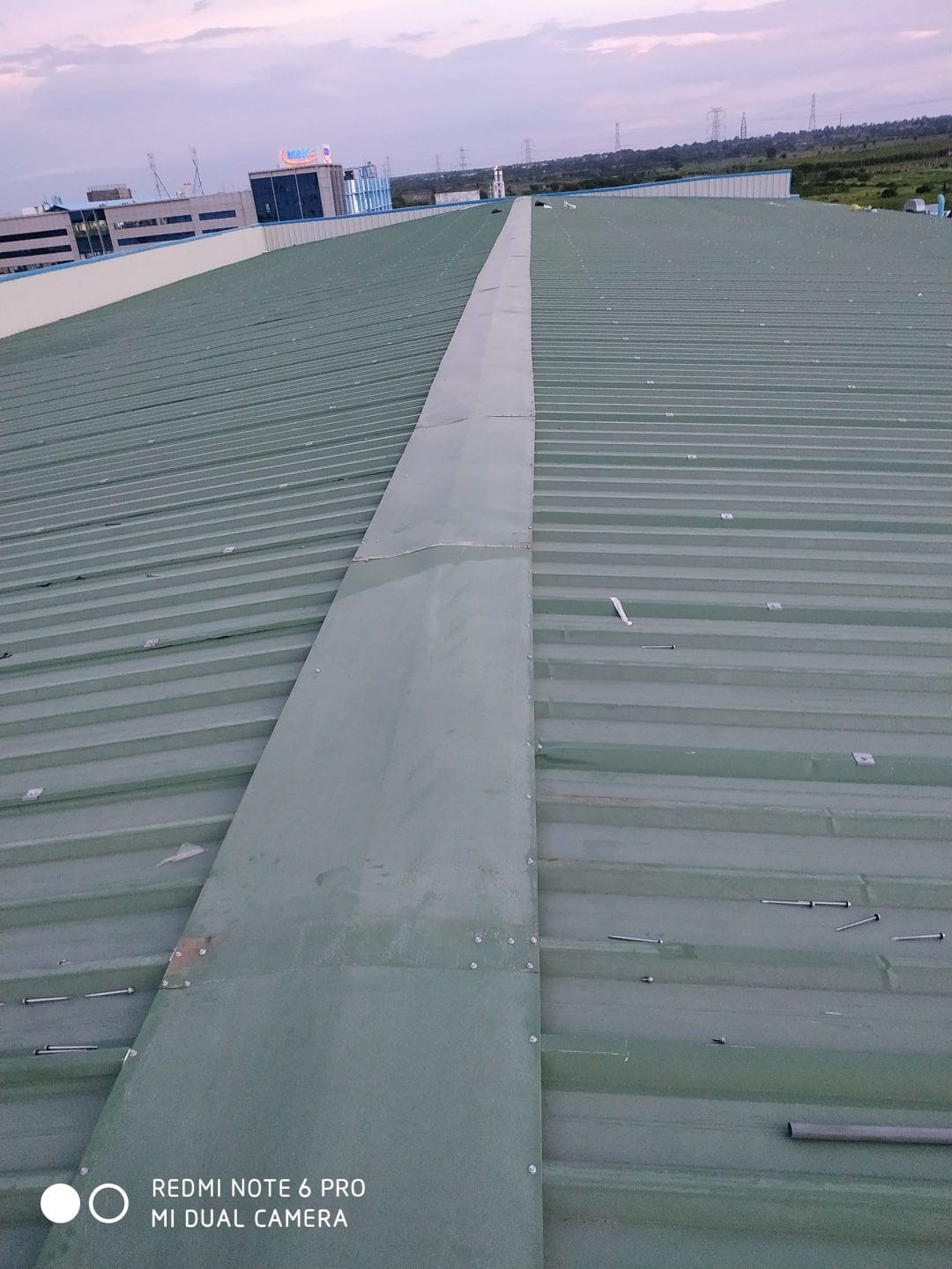 Insulated roofing panel installation